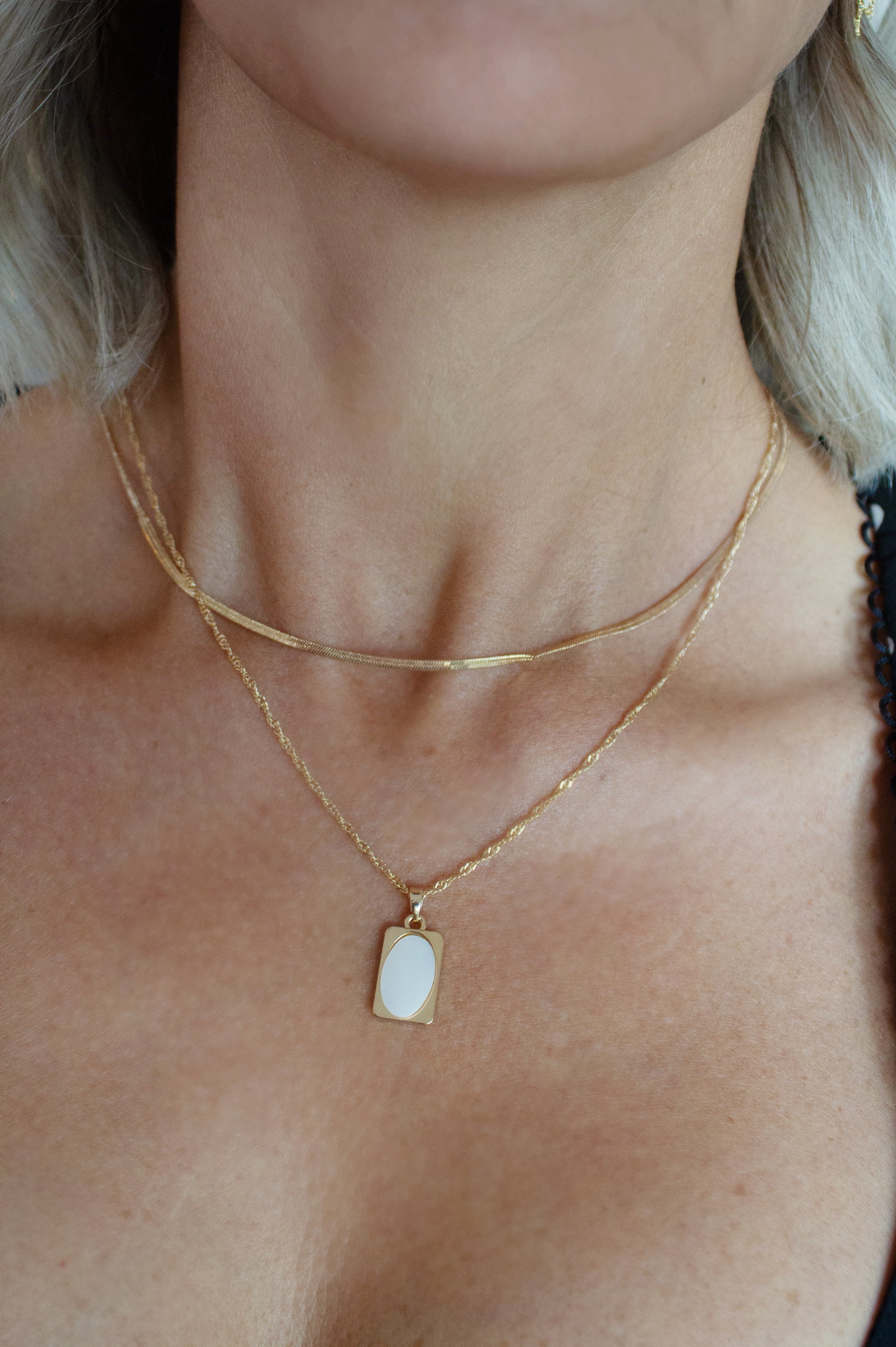 Later gold necklace with white shell charm