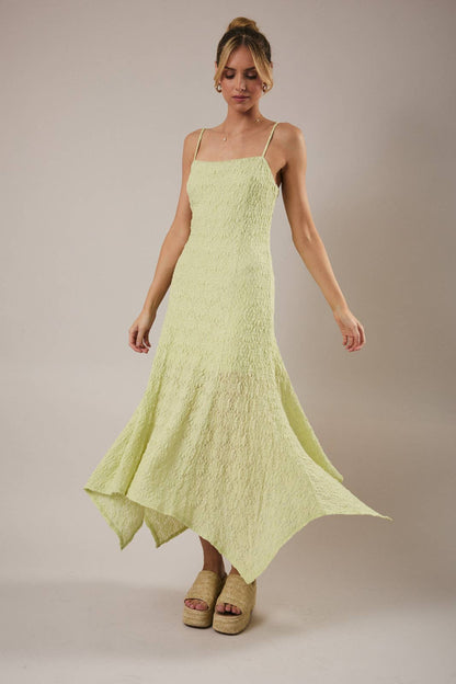 Woman wearing a light green dress against a plain background