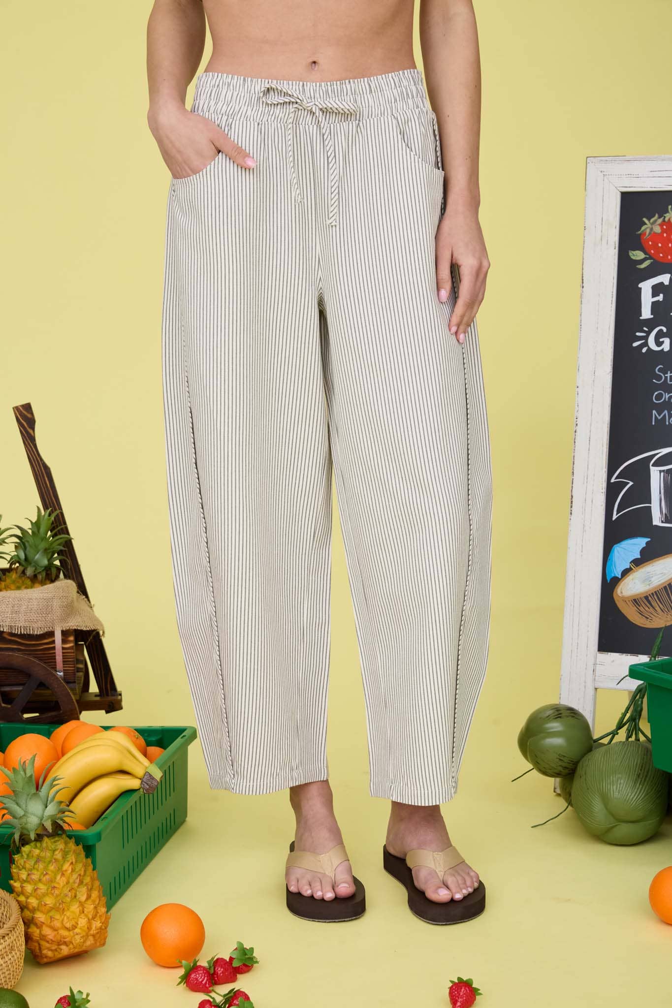 Person wearing striped pants that tie at the waist