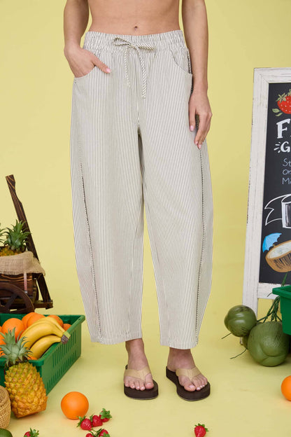 Person wearing striped pants that tie at the waist