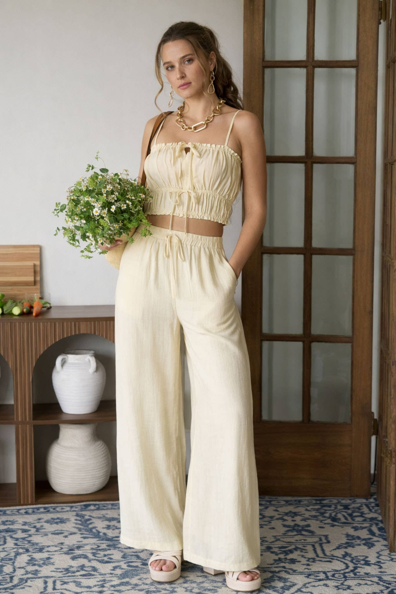 Woman wearing a yellow outfit wearing a crop top and matching pants