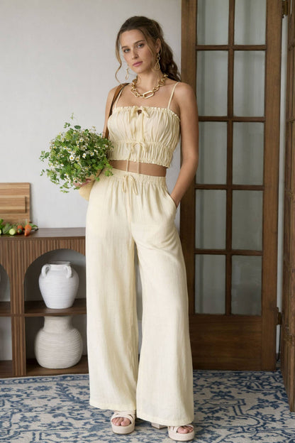 Woman wearing a yellow outfit wearing a crop top and matching pants